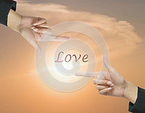 Closeup love word at the center frame by hand of working woman on beautiful evening sky textured background in work concept