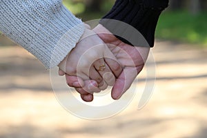 Closeup of loving couple holding hands