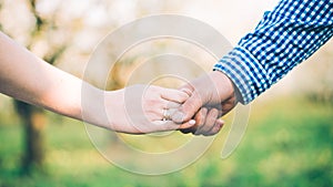 Closeup of loving couple holding hands