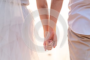 Closeup of loving couple holding hands