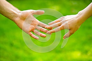 Closeup of loving couples holding hands while walking. Female and male hand together. Couple holding hands in the Park