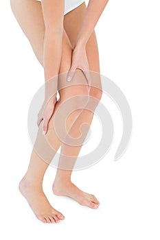 Closeup low section of a fit woman with leg pain