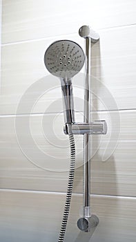 Closeup on a luxurious bathtub with the shower head on
