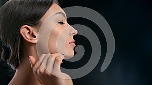 Closeup luxury brunette female model stroking perfect skin chin neck enjoy cosmetology procedure