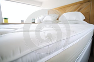 closeup of a luxury mattress topper on a kingsize bed