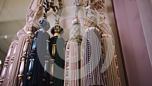 closeup of luxury tieback tassel curtain accessory with fringe at textile store