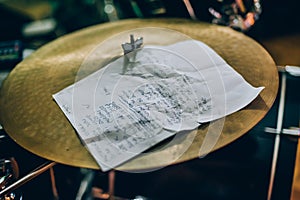 Closeup of lyrics paper with a song text lying on drum set