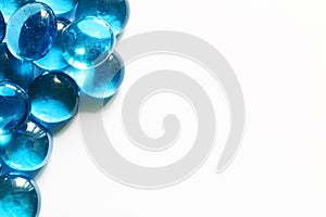 Blue glass spheres on white background. Closeup macro abstract