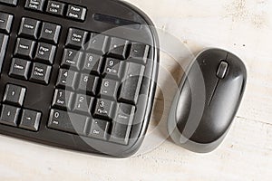 Closeup macro black pc keyboard with black wireless mouse