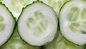 Closeup macro of fresh cucumber slices with seeds and green skin on edges, Horizontal vegetable banner. Macro background about raw