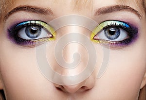 Closeup macro image of human female eye with violet, blue and an