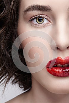 Closeup macro portrait of female face. Human woman half-face with unusual beauty makeup. Girl with perfect skin, green pistachio