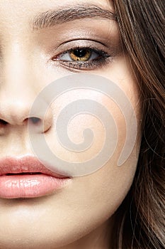 Closeup macro portrait of female face with pink lips and smoky eyes beauty makeup