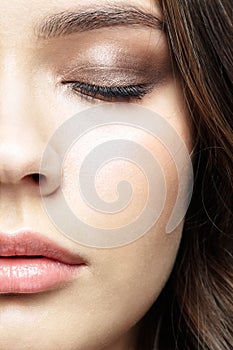 Closeup macro portrait of female face with red lips and smoky eyes beauty makeup