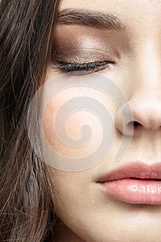 Closeup macro portrait of female face with red lips and smoky eyes beauty makeup