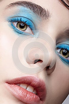 Closeup macro portrait of female face. Woman  with unusual beauty makeup. Girl with perfect skin, green pistachio colour eyes and