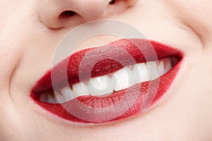 Closeup macro portrait of female red smiling lips with day beauty makeup