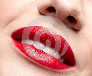 Closeup macro portrait of female red smiling lips with day beauty makeup