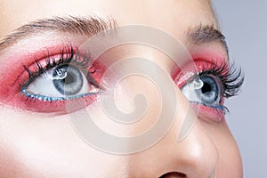 Closeup macro shot of female face and pink smoky eyes makeup