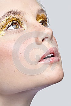 Closeup macro shot of human female eye with yellow smoky eyes beauty makeup