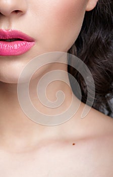 Closeup shot of human female face with pink lips makeup photo