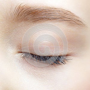 Closeup macro shot of human teenager female closed eye