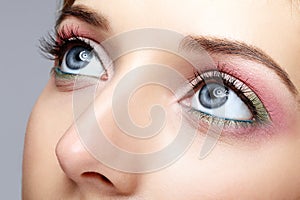 Closeup macro shot of human woman face with eyes day makeup