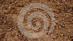 Closeup of macro view of red dirt or mud of pile soil from agriculture land. Soil Background