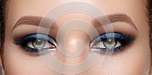 Closeup Macro of Woman Face with Green Eyes Make-up. Fashion Celebrate Makeup, Glowy Clean Skin, perfect Shapes of Brows