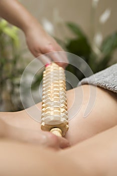 Maderotherapy anti-cellulite massage with wooden roller massager photo