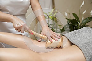 Maderotherapy anti-cellulite massage with wooden roller massager photo