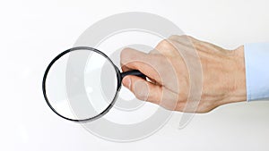 Closeup. magnifier in the hand of businessman.