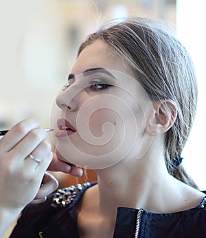 Closeup of a makeup artist applying makeup