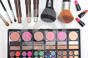 Closeup makeup cosmetics palette lipstick and brushes