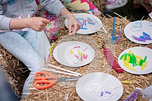 Closeup of making bracelets with plastic tubes