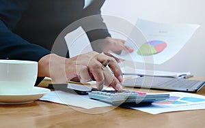 Closeup of male accountants who are pressing on the calculator