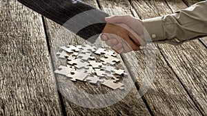 Closeup of male and female business partners shaking hands over