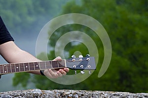 Closeup of male guitarist hand playing guitar