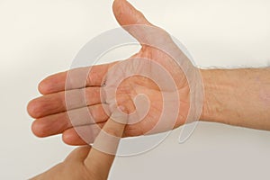 closeup of male hand of adult mature man in gesture fingers holding, palm reading, shows, open palm on white background, concept