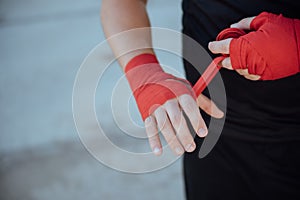 Closeup male hand of boxer with red boxing bandages