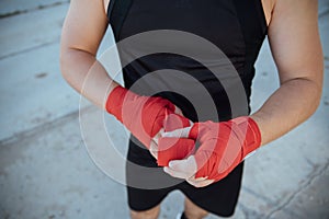 Closeup male hand of boxer with red boxing bandages