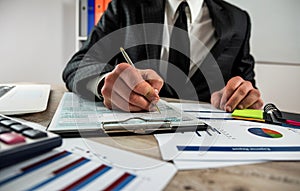 closeup male hand filling finance report document tax form