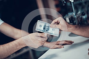 Closeup of Male Hand Gives Money to Seller