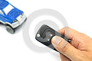 Right hand holding remote control car key for business concept