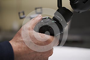 Closeup of a male hand regulating a handheld camera