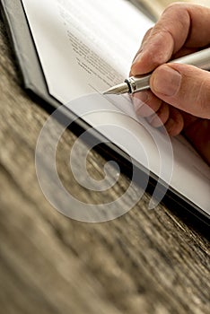 Closeup of male hand signing business contract, subscription for