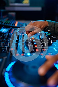 Closeup male hand on sound mixer console