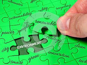 Closeup male hands holding missing jigsaw environment tag cloud green puzzle. Ecology clean energy renewable sustainability