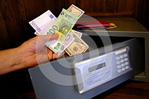 closeup male hands holds 50, 500 euro banknotes of european union, personal documents, tourist puts money in hotel safe with