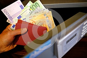 closeup male hands holds 50, 500 euro banknotes of european union, personal documents, tourist puts money in hotel safe with